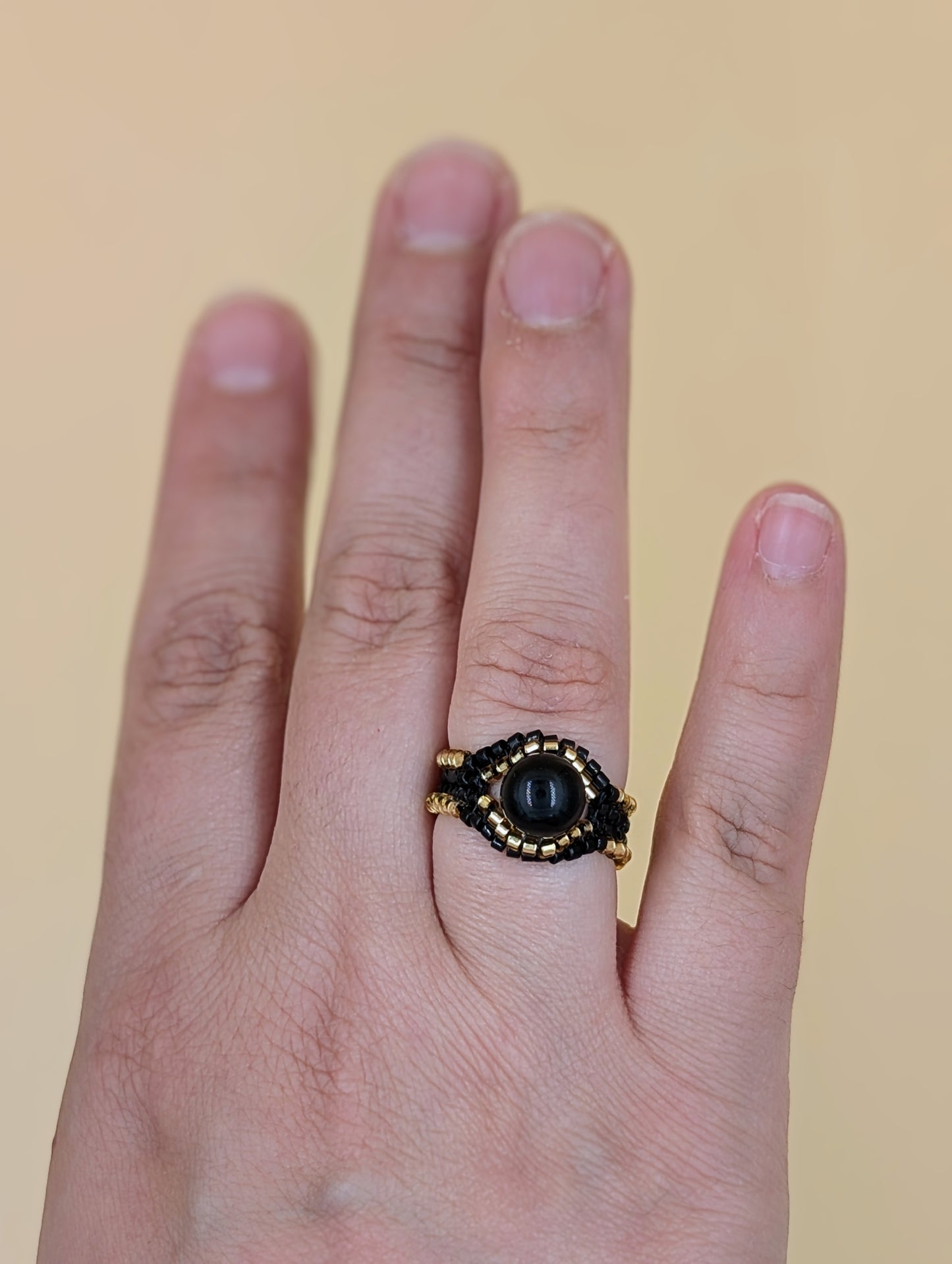 Bague artisanale Icarus, tissée en perles Miyuki et obsidienne dorée